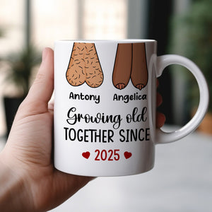 Personalized couple mug featuring playful design with names and the phrase Growing Old Together Since 2025