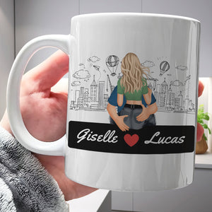 Personalized couple mugs featuring a custom illustration of Giselle and Lucas on a cityscape background