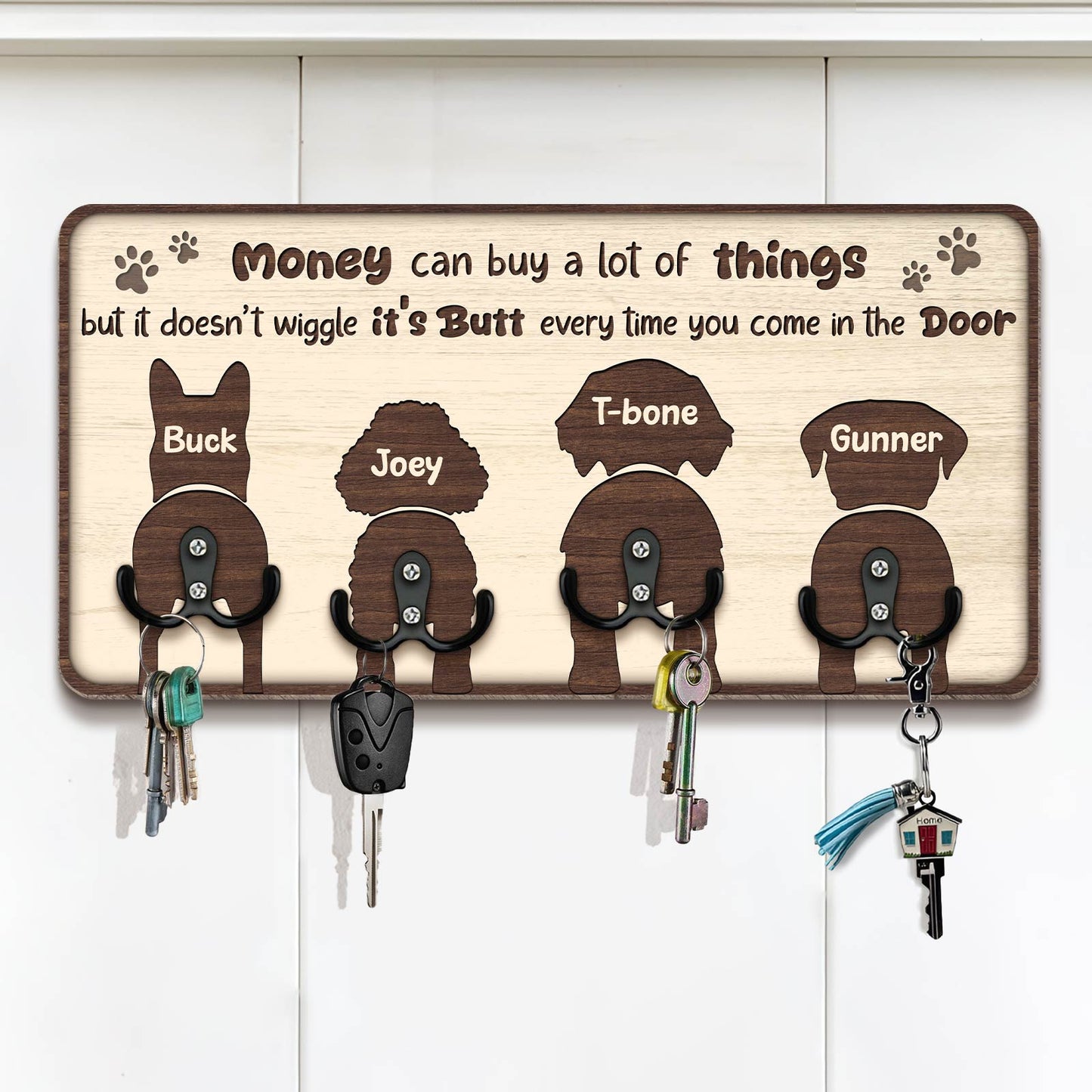 Personalized dog key holder featuring silhouettes of four dogs with hooks for keys and humorous text