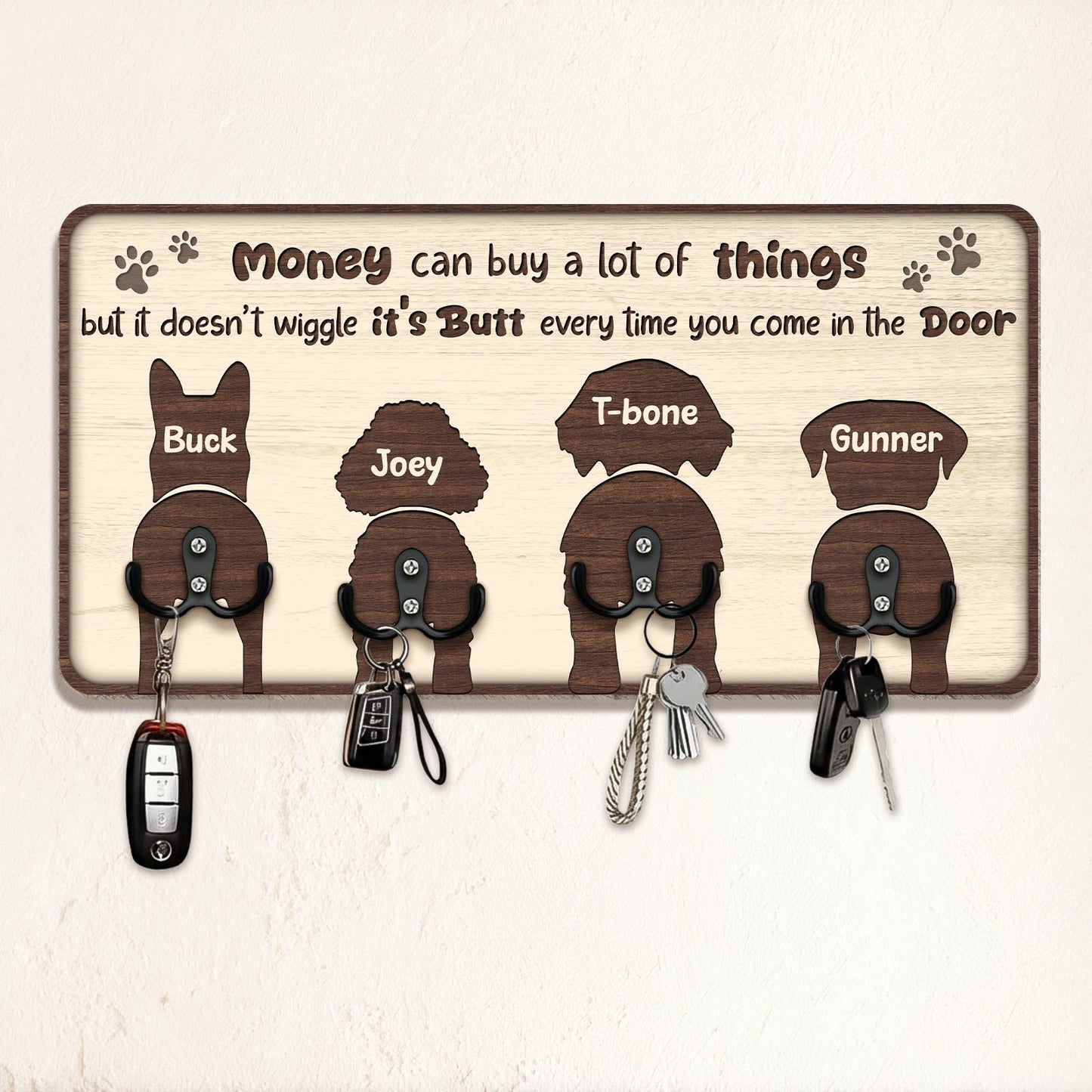 Personalized dog key holder with silhouette designs of four dogs and humorous quote about pets