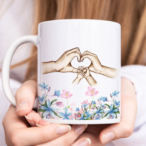 Personalized family mug featuring hands forming a heart with floral design for cherished moments