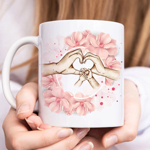 Personalized family mug featuring hands making a heart shape with pink floral accents