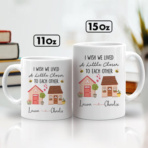 Personalized friends mug featuring two houses and custom names Laura and Charlie