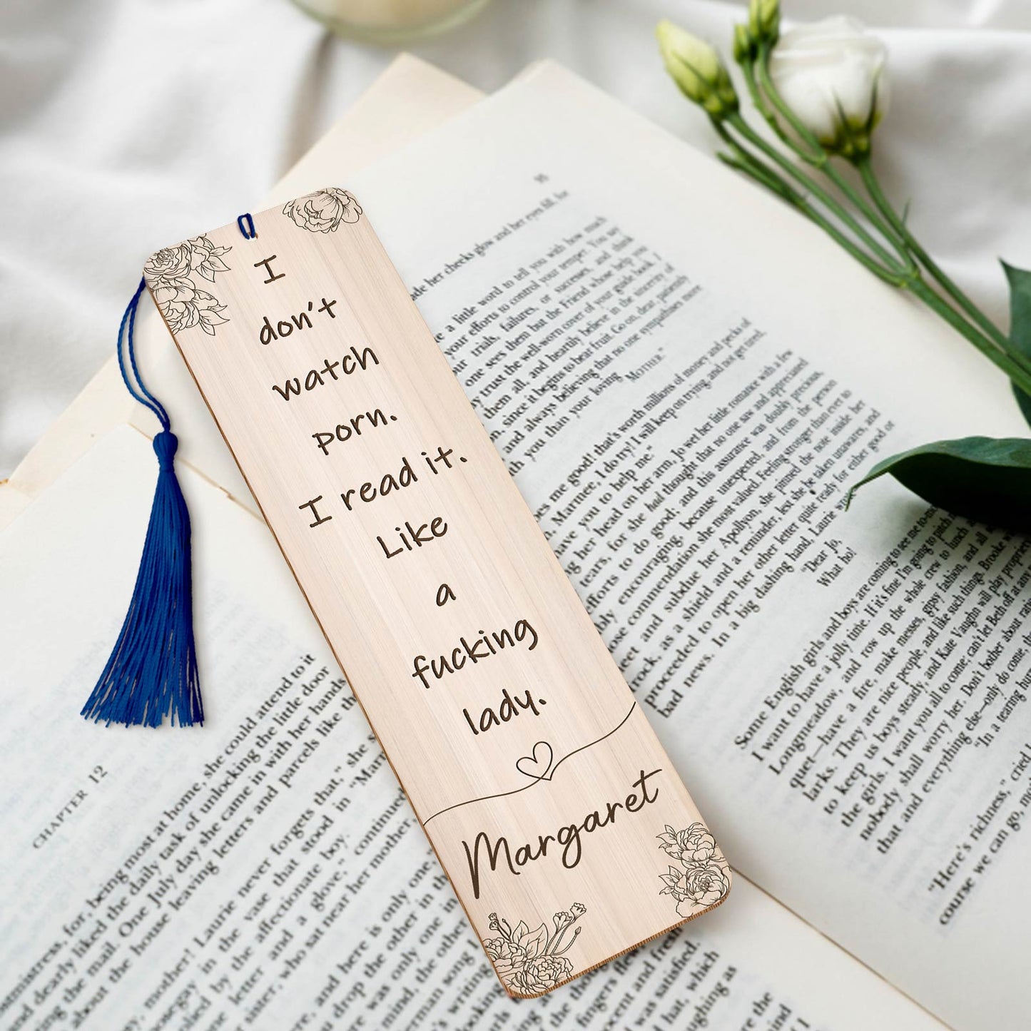 Personalized funny bookmark for women with a humorous quote and floral design on a wooden surface