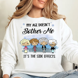 White sweatshirt featuring a humorous design saying My Age Doesn't Bother Me It's the Side Effects for a personalized funny shirt