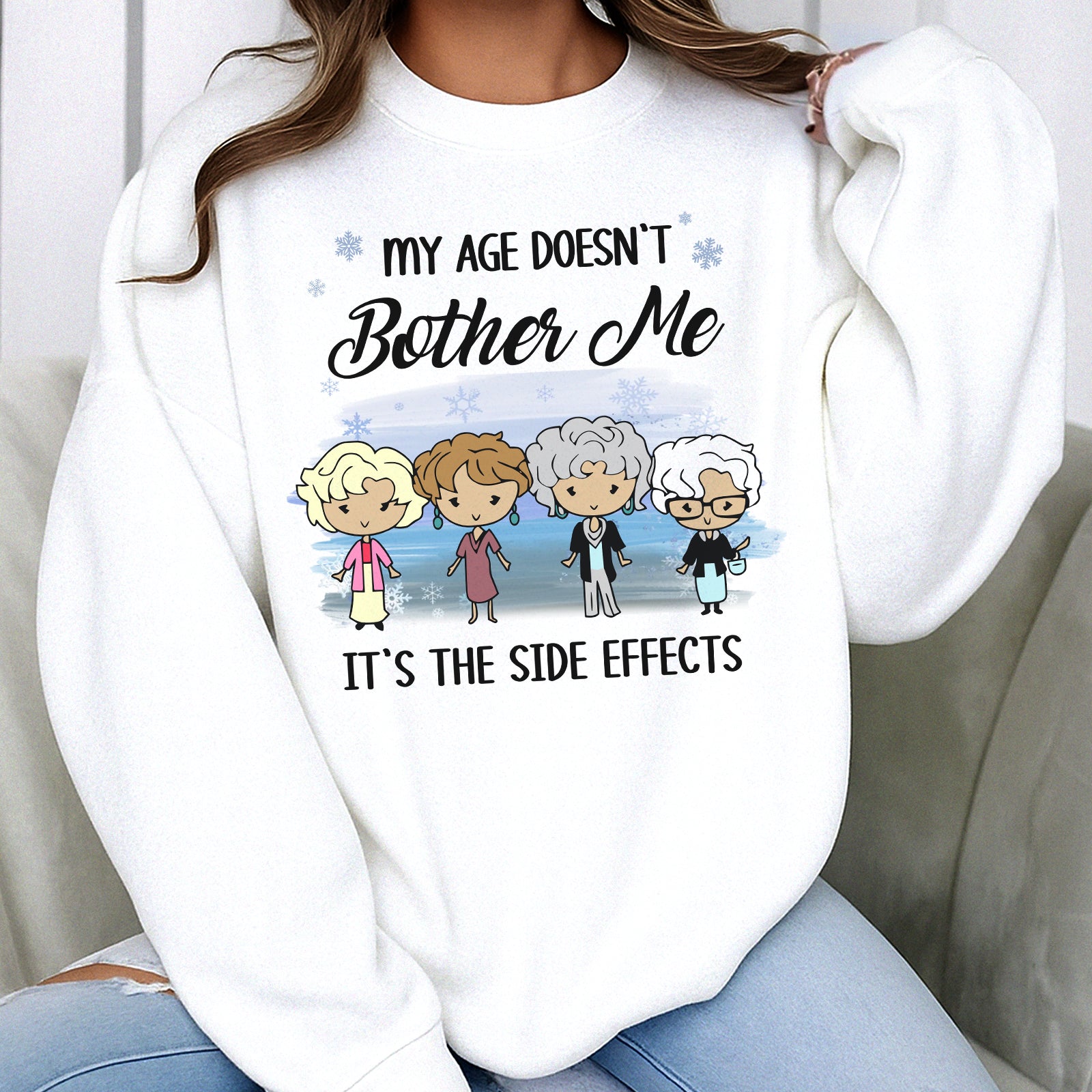White sweatshirt with a design saying My Age Doesn't Bother Me It's the Side Effects, personalized funny shirt
