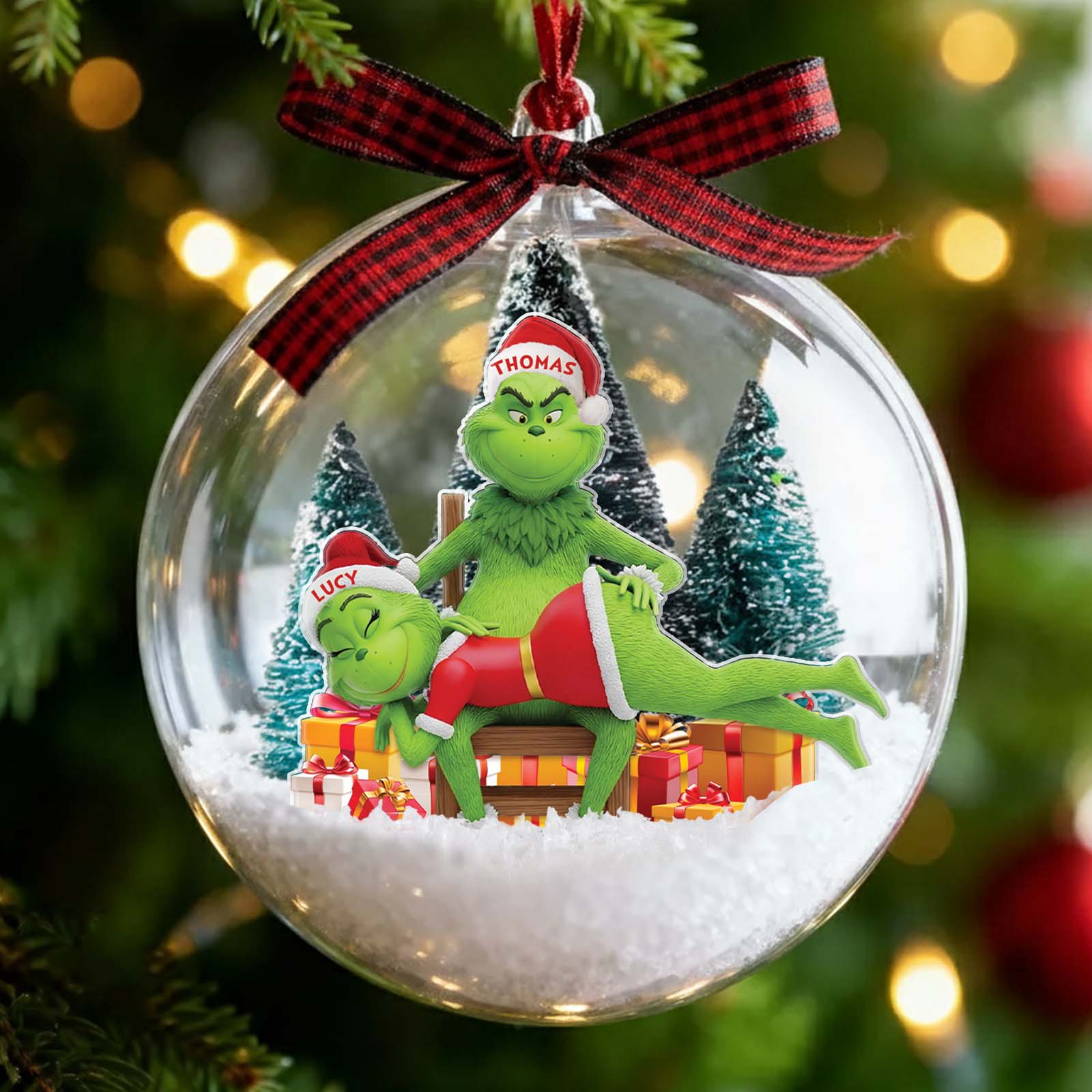 Personalized Grinch couple ornament inside a festive glass ball with holiday decorations