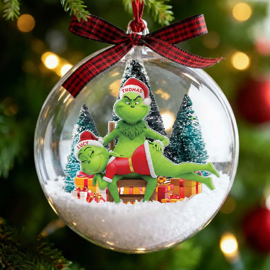 Personalized Grinch couple ornament inside a festive glass ball with holiday decorations