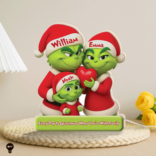 Personalized Grinch family light box featuring green characters holding a heart with custom names