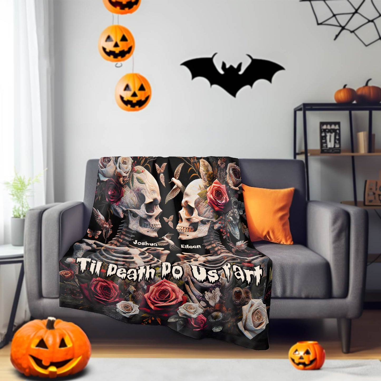 Personalized Halloween couple blanket with skulls, roses, and names Joshua and Edison on gray sofa