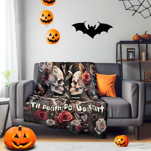 Personalized Halloween couple blanket with skulls, roses, and names Joshua and Edison on gray sofa