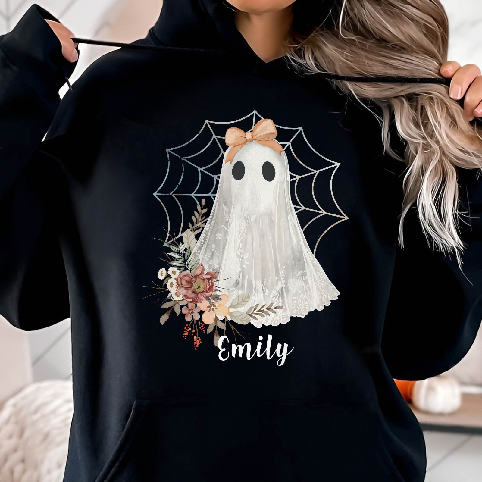 Black hoodie featuring a personalized Halloween ghost shirt with floral design and spider web background
