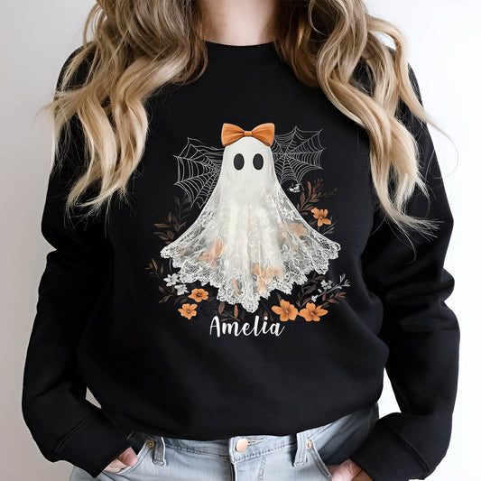 Black personalized Halloween shirt with cute ghost design and name Amelia, decorated with spider webs and orange flowers