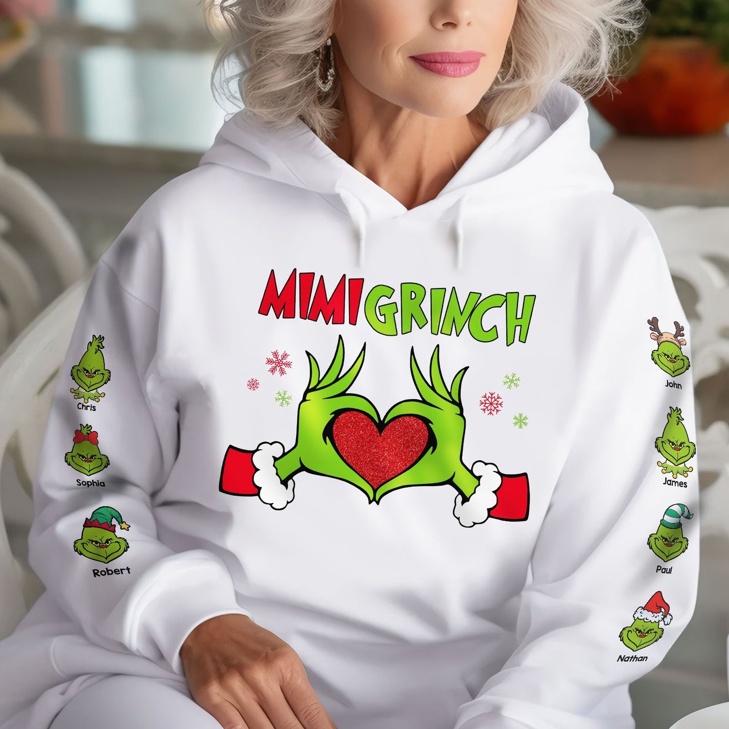 White personalized Mimi Grinch Christmas shirt with green Grinch hands forming a heart and names on sleeves