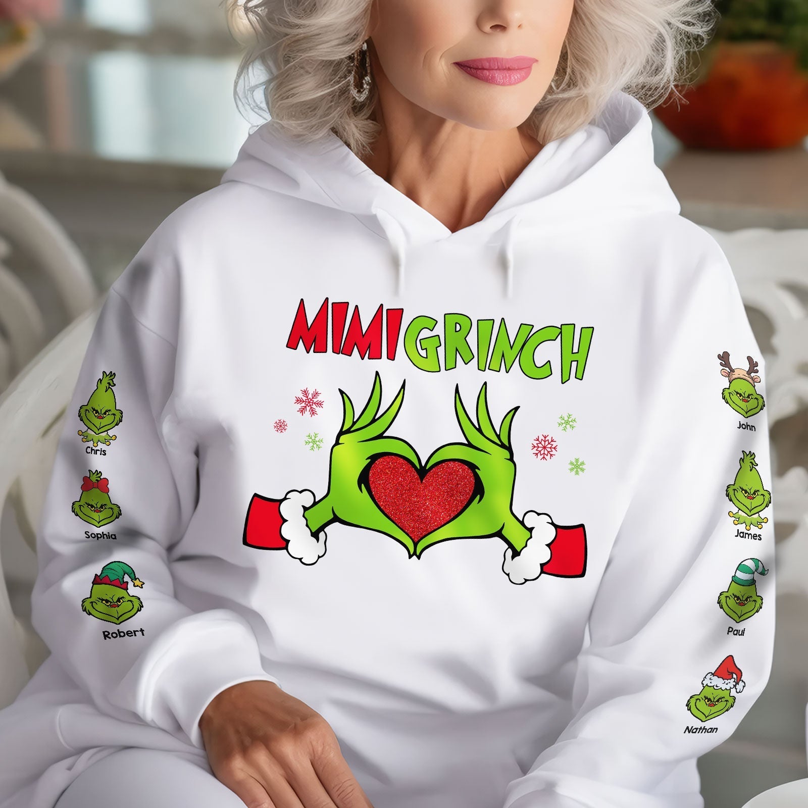 White personalized Mimi Grinch Christmas shirt with green Grinch hands forming a heart and names on sleeves