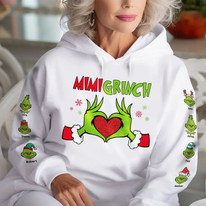 White personalized Mimi Grinch Christmas shirt with green Grinch hands forming a heart and names on sleeves