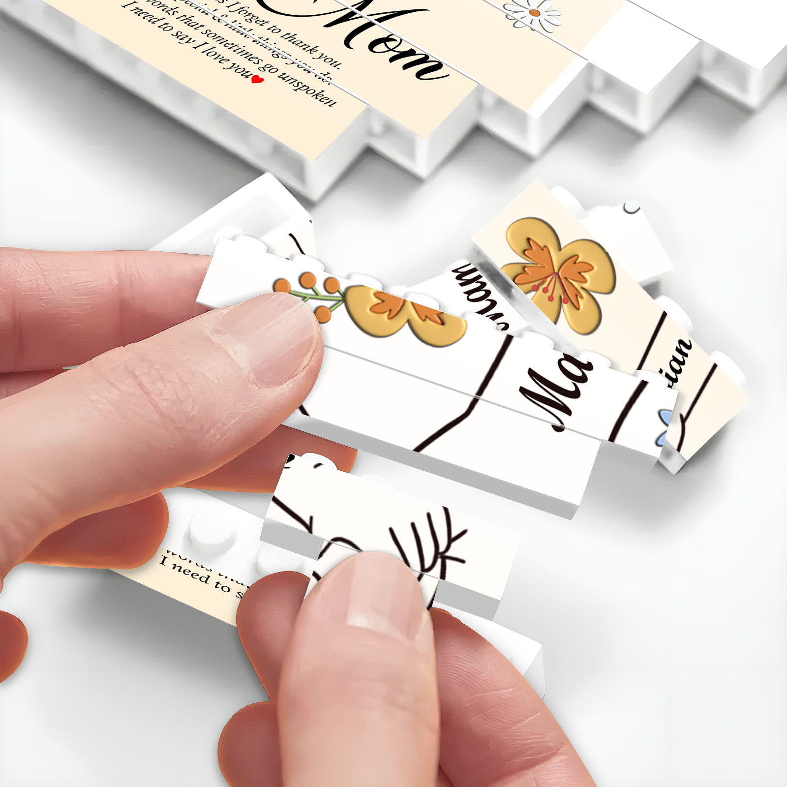 Close-up of hands assembling a personalized mom jigsaw puzzle with floral designs