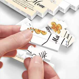 Close-up of hands assembling a personalized mom jigsaw puzzle with floral designs