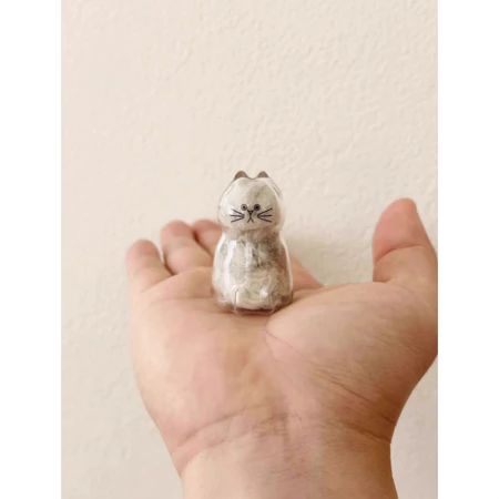 Cute personalized pet keepsake gift shaped like a cat, held in a person's hand
