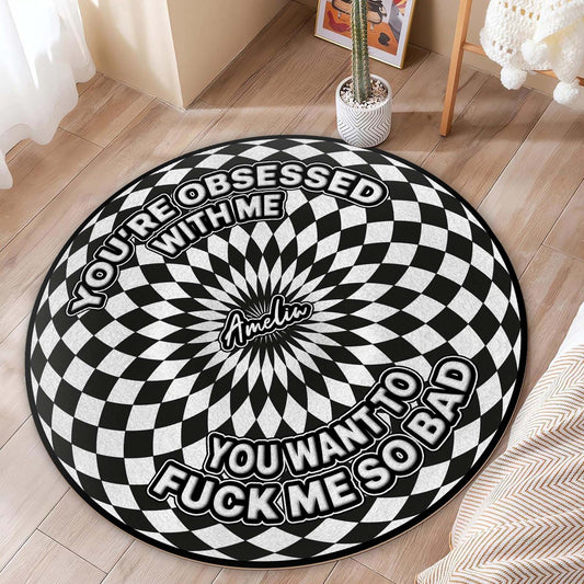 Personalized round mat featuring a striking black and white spiral design with a bold message
