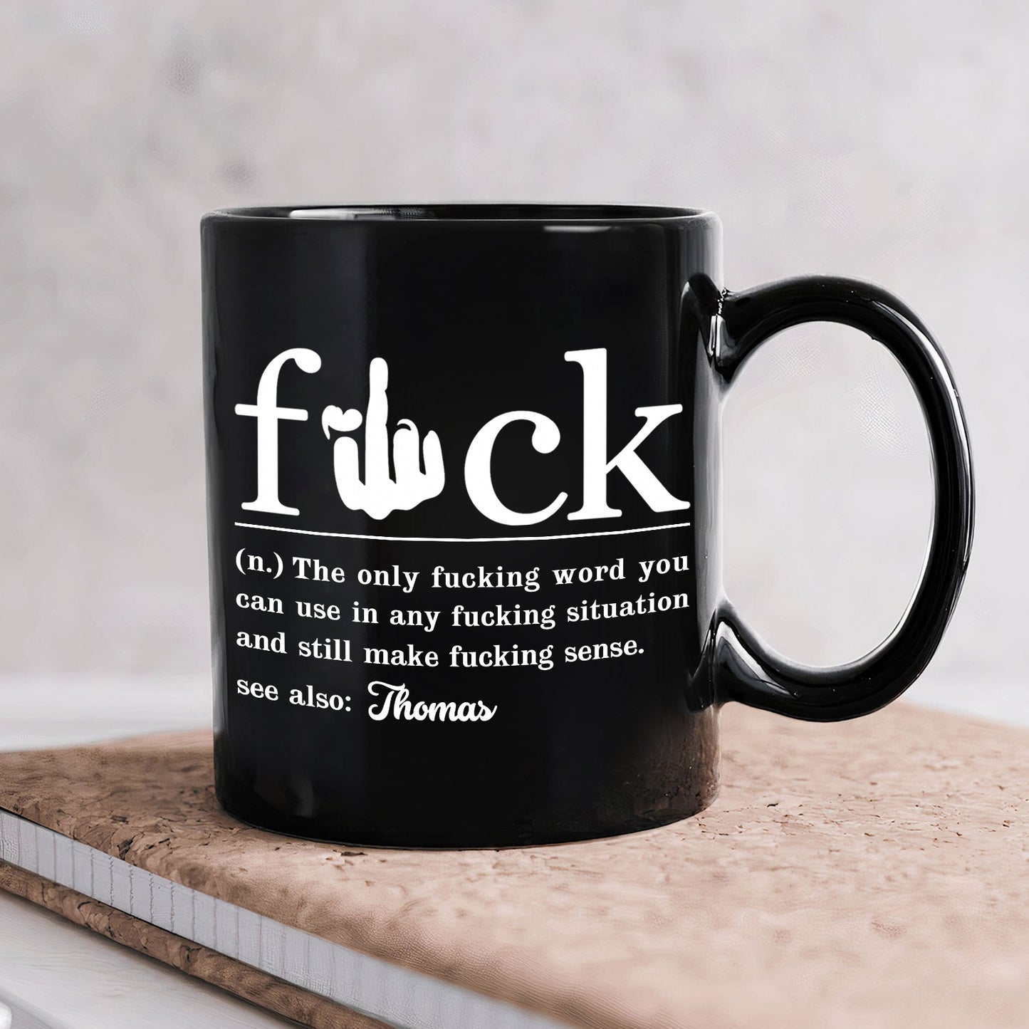 Black personalized sarcastic coffee mug with humorous text definition about a commonly used expletive
