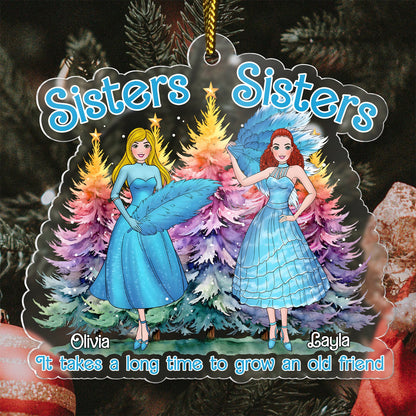Personalized sisters Christmas ornament with two women in blue dresses and colorful Christmas trees