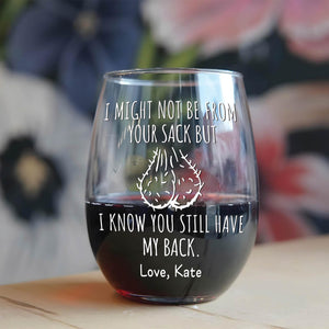 Personalized stepdad wine glass with humorous text and custom name, filled with red wine