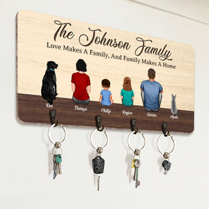 Personalized wooden key hanger featuring a family illustration with key holders for organization