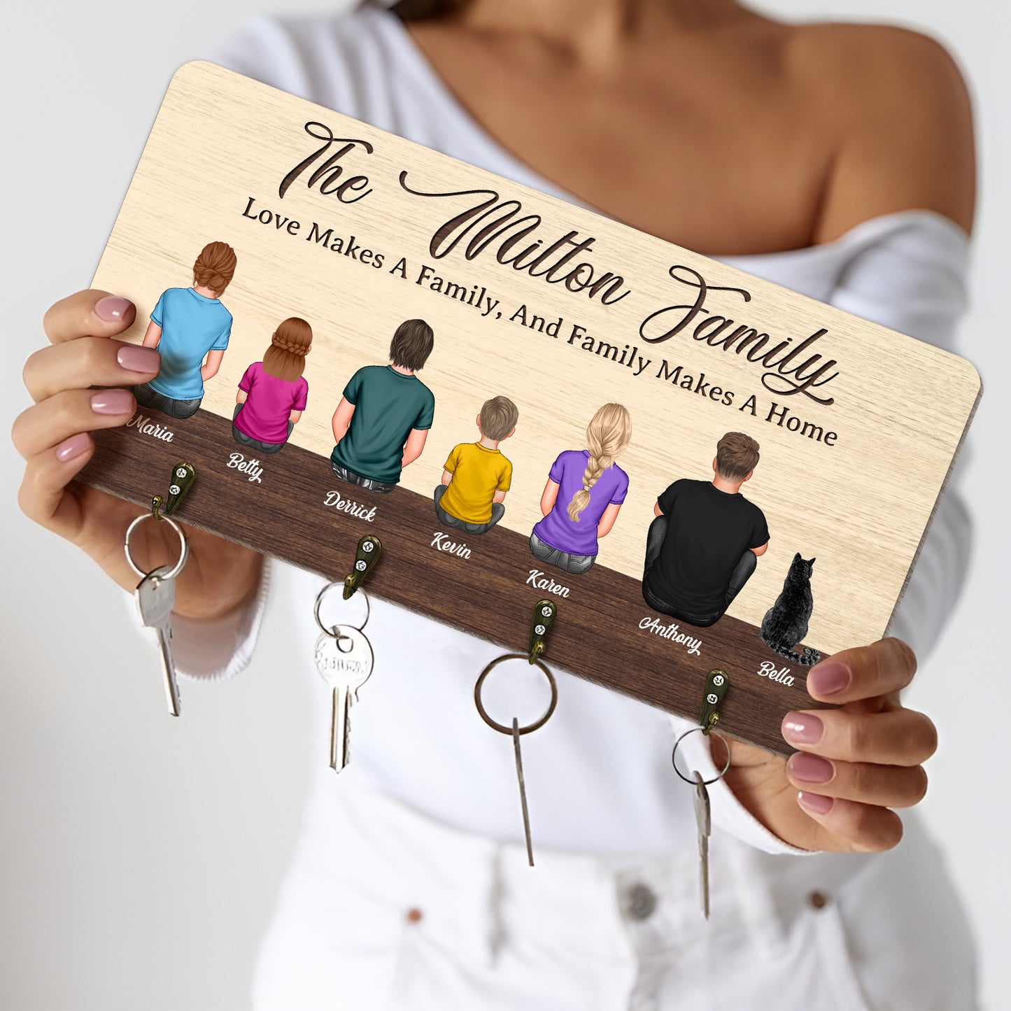 Personalized wooden key hanger featuring family silhouettes and key hooks for organized home entry