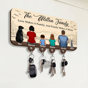 Personalized wooden key holder featuring a family illustration with space for four key hooks