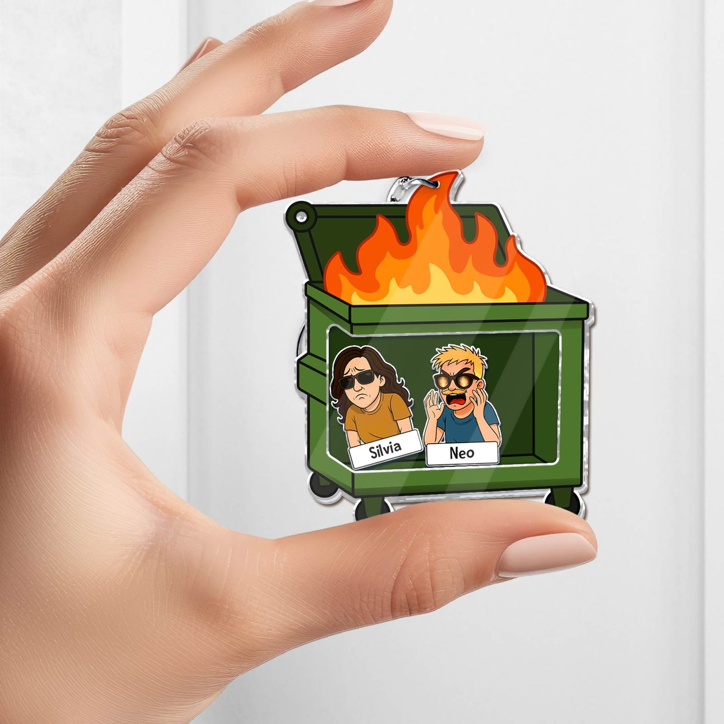 Shaking Keychain For Coworker featuring a green dumpster with flames and cartoon coworker characters