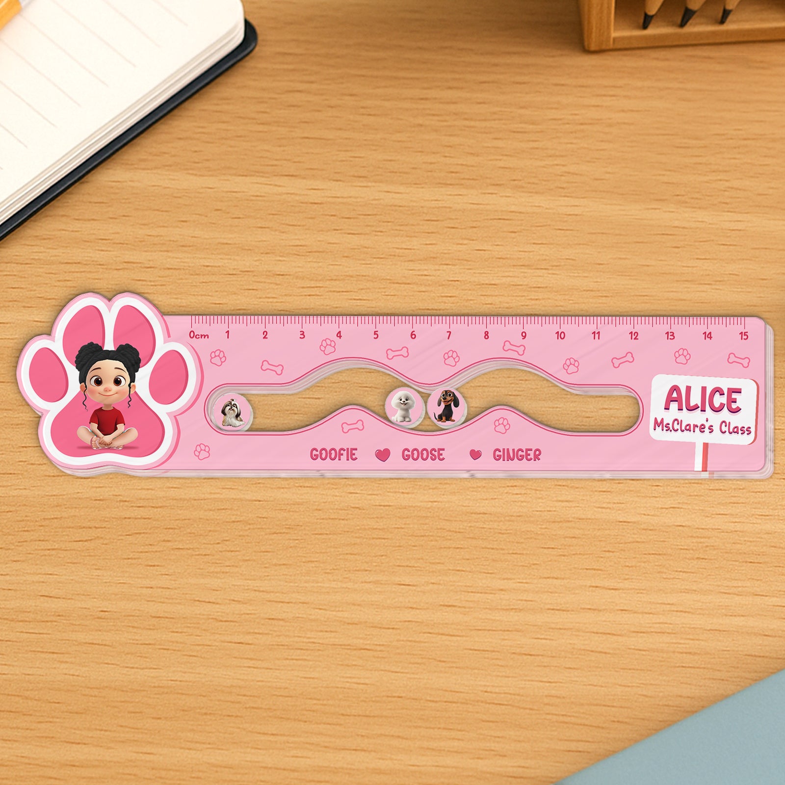 365Gifty pink Shaking Ruler for Kids with character designs and wave-shaped track on wooden desk