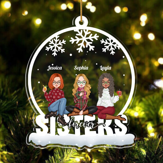 Customizable acrylic ornament featuring three sisters with names in festive winter attire and snowflakes