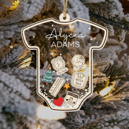 Personalized baby's first Christmas ornament shaped like a onesie with name and birth details
