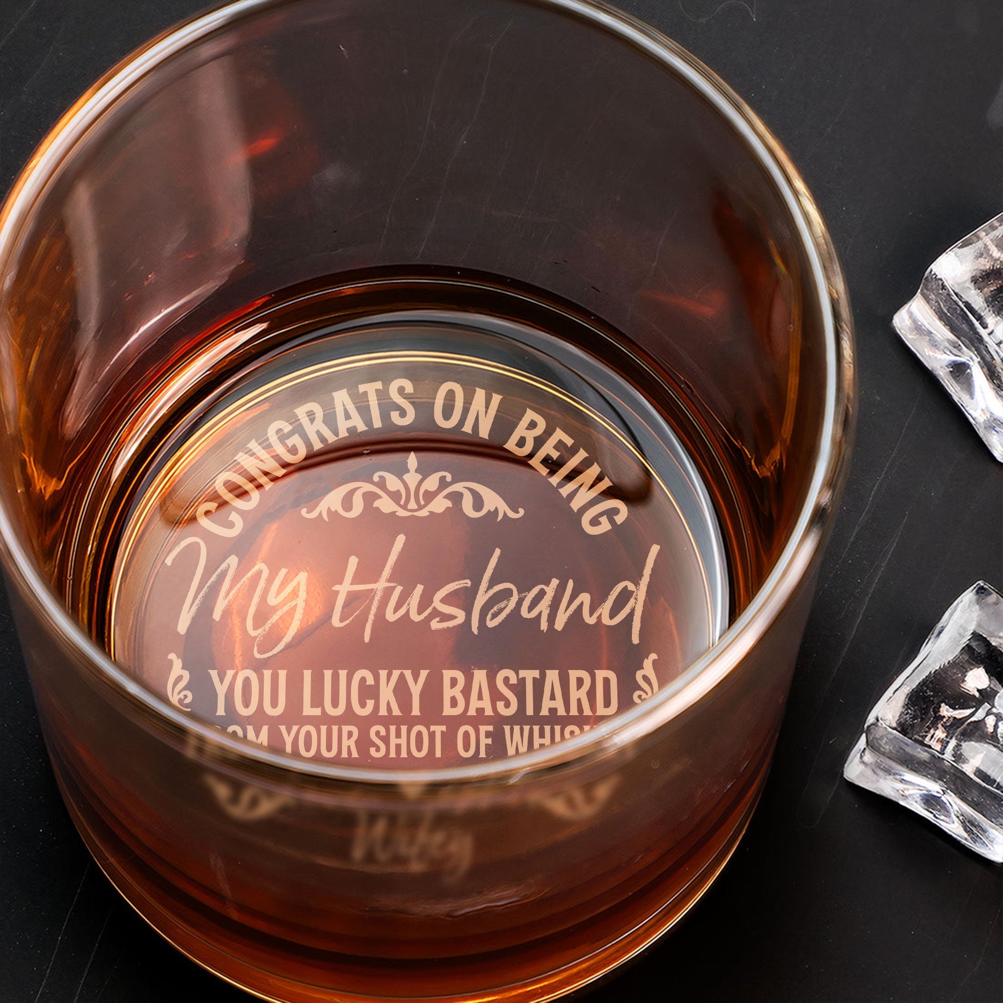 Personalized Whiskey Glass engraved with Congrats on Being My Husband message filled with amber whiskey