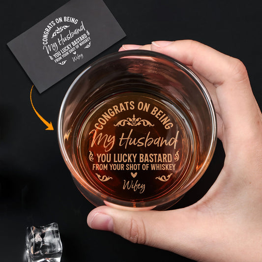 Personalized Whiskey Glass held in hand showing engraved Congrats on Being My Husband message with whiskey