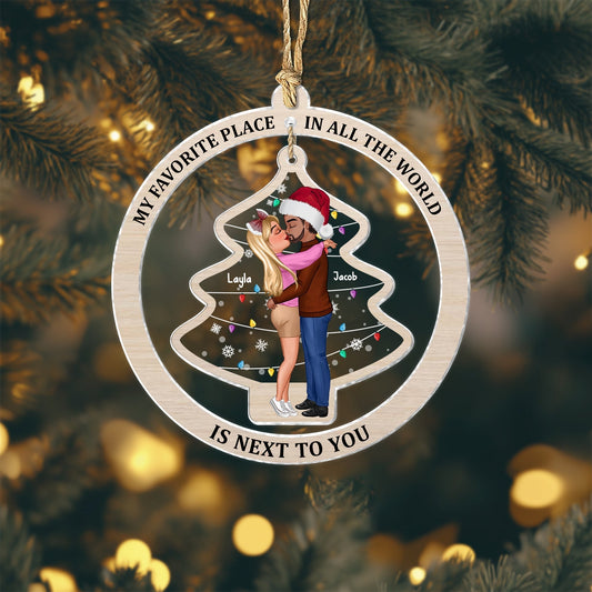 Personalized couple ornament featuring a kissing couple inside a Christmas tree frame with the phrase My favorite place in all the world is next to you
