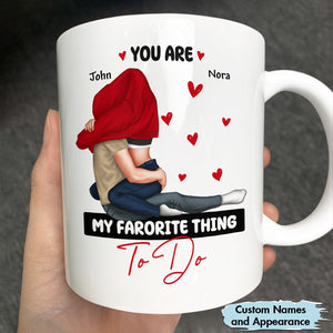 White personalized you are my favorite thing to do mug with a couple hugging and custom names John and Nora